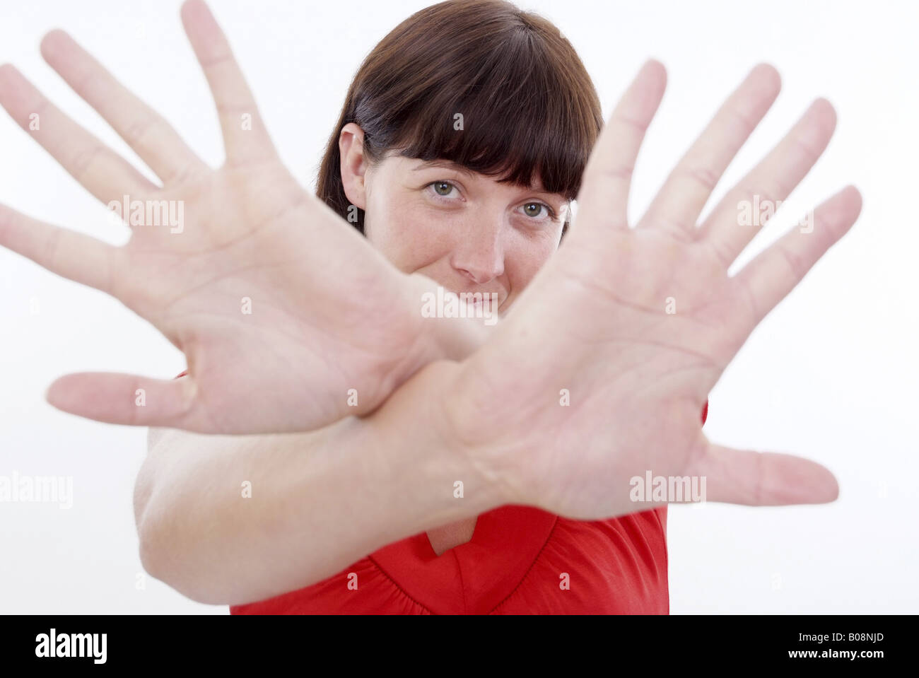 woman cups hands in  front of her face Stock Photo
