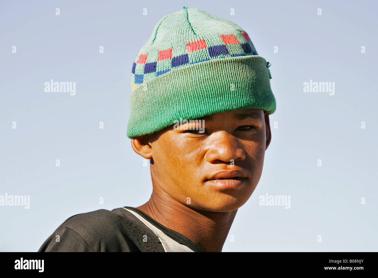 Namibian teenage boy wearing green knitted woolen hat, Namibia, Africa Stock Photo