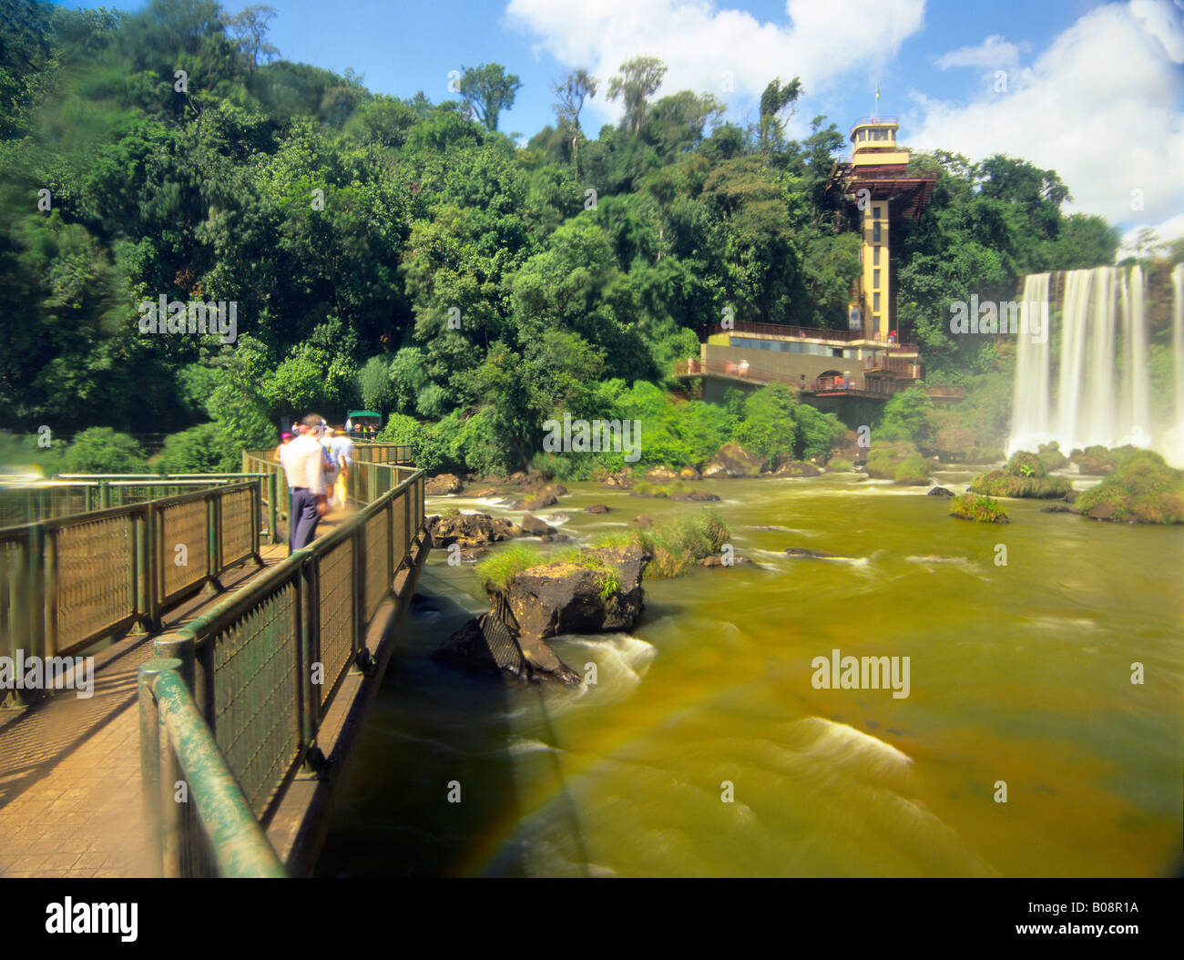 South America, Brazil, Igwacu Falls. Tourists stroll the boardwalk to see every dramatic angle of Igwacu Falls. Stock Photo