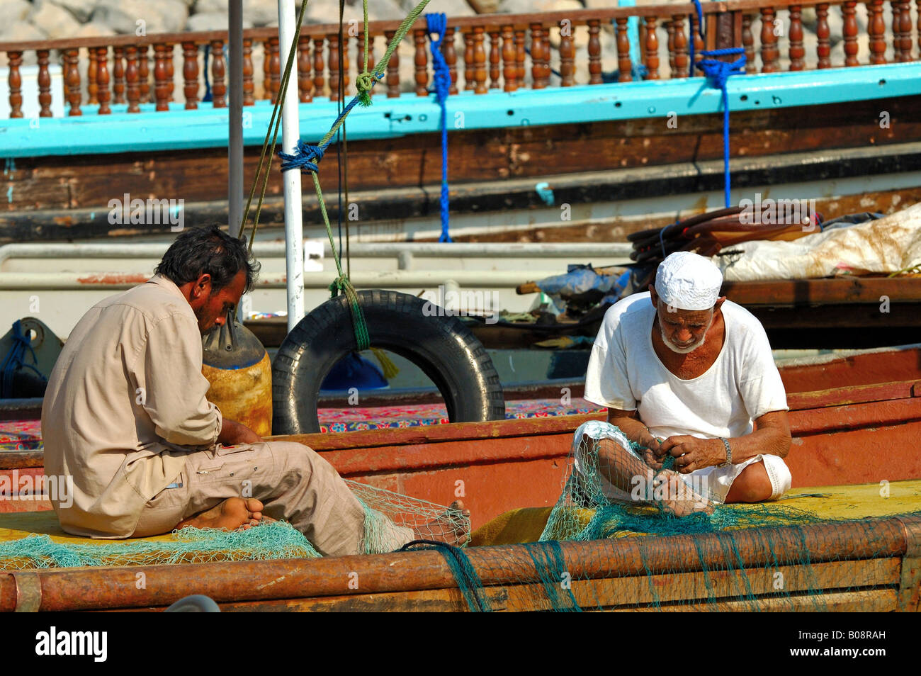 Fishermen mending their fishing nets, Khasab, Musandam, Oman, Middle East Stock Photo