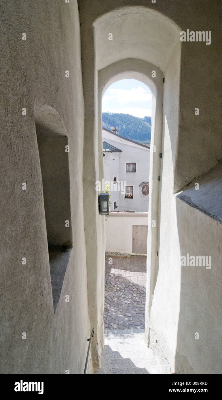 View down a narrow covered stairway between two buildings in the historic centre of Hall, Tyrol, Austria Stock Photo