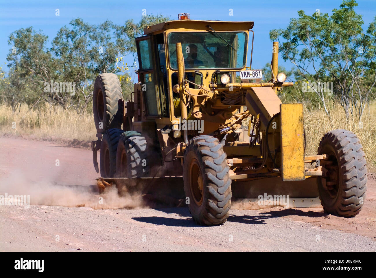 Road grader scraping a dirt road, Gibb River Road, Australia Stock Photo