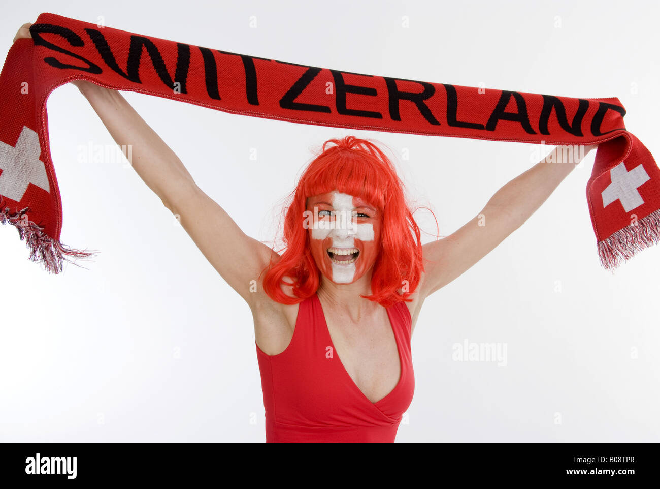 woman as Switzerland fan, holding a fan scarf over her head Stock Photo