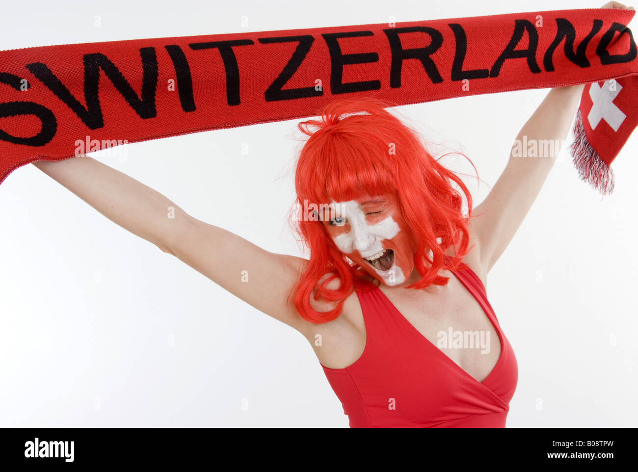 woman as Switzerland fan, holding a fan scarf over her head Stock Photo
