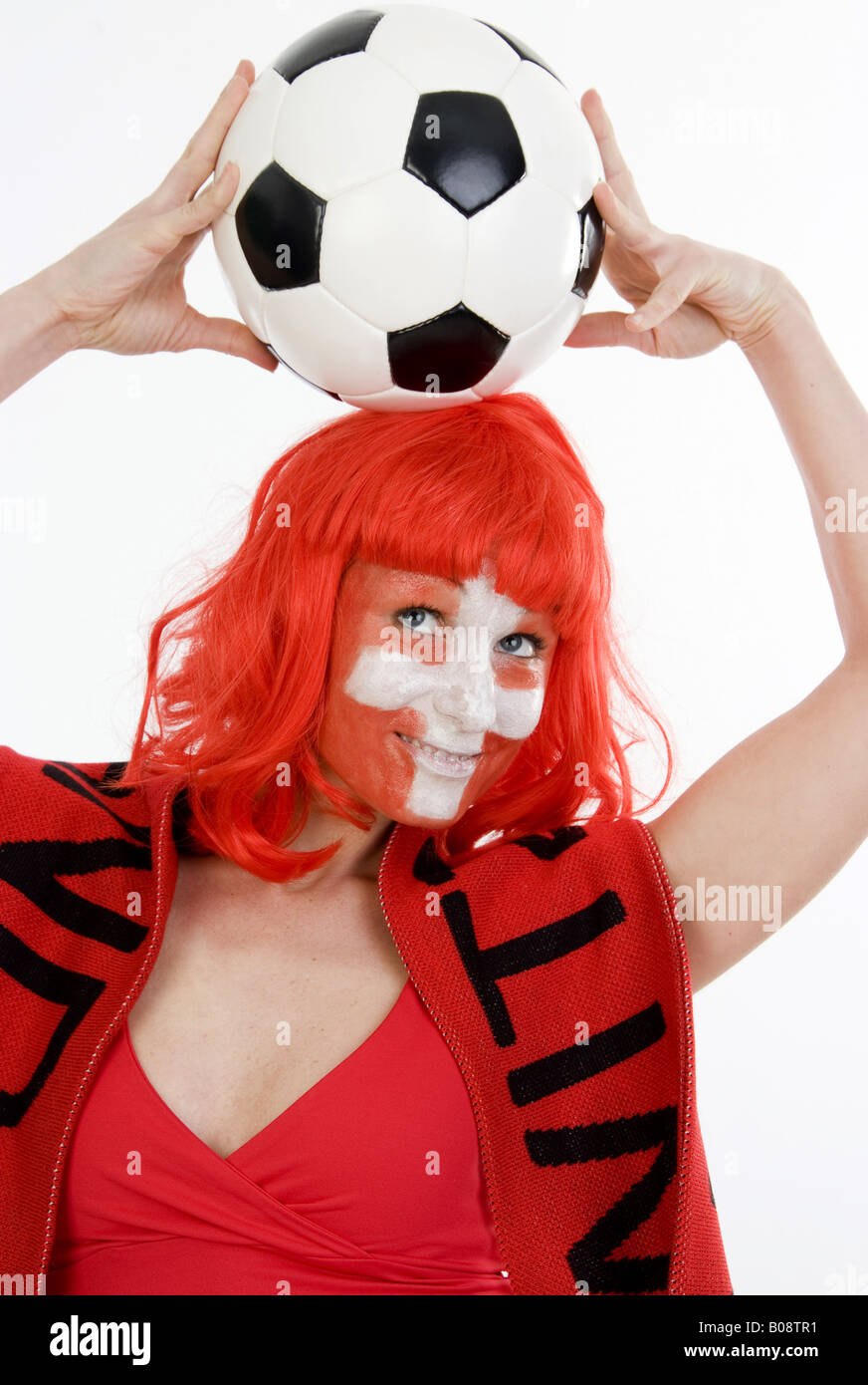 woman as Switzerland fan, with fan scarf and football Stock Photo