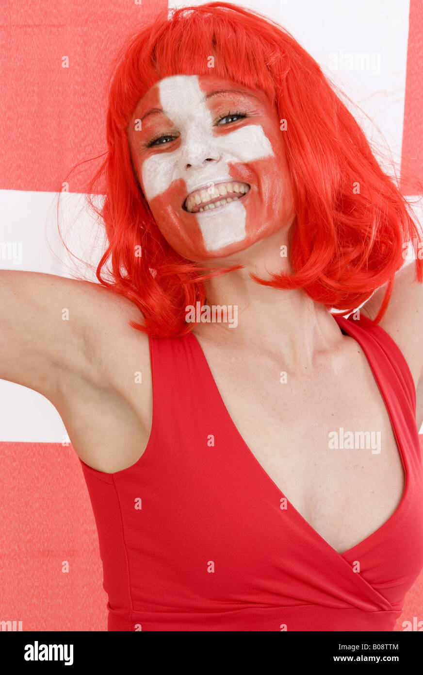 woman as Switzerland fan, cheering and with Swiss flag Stock Photo