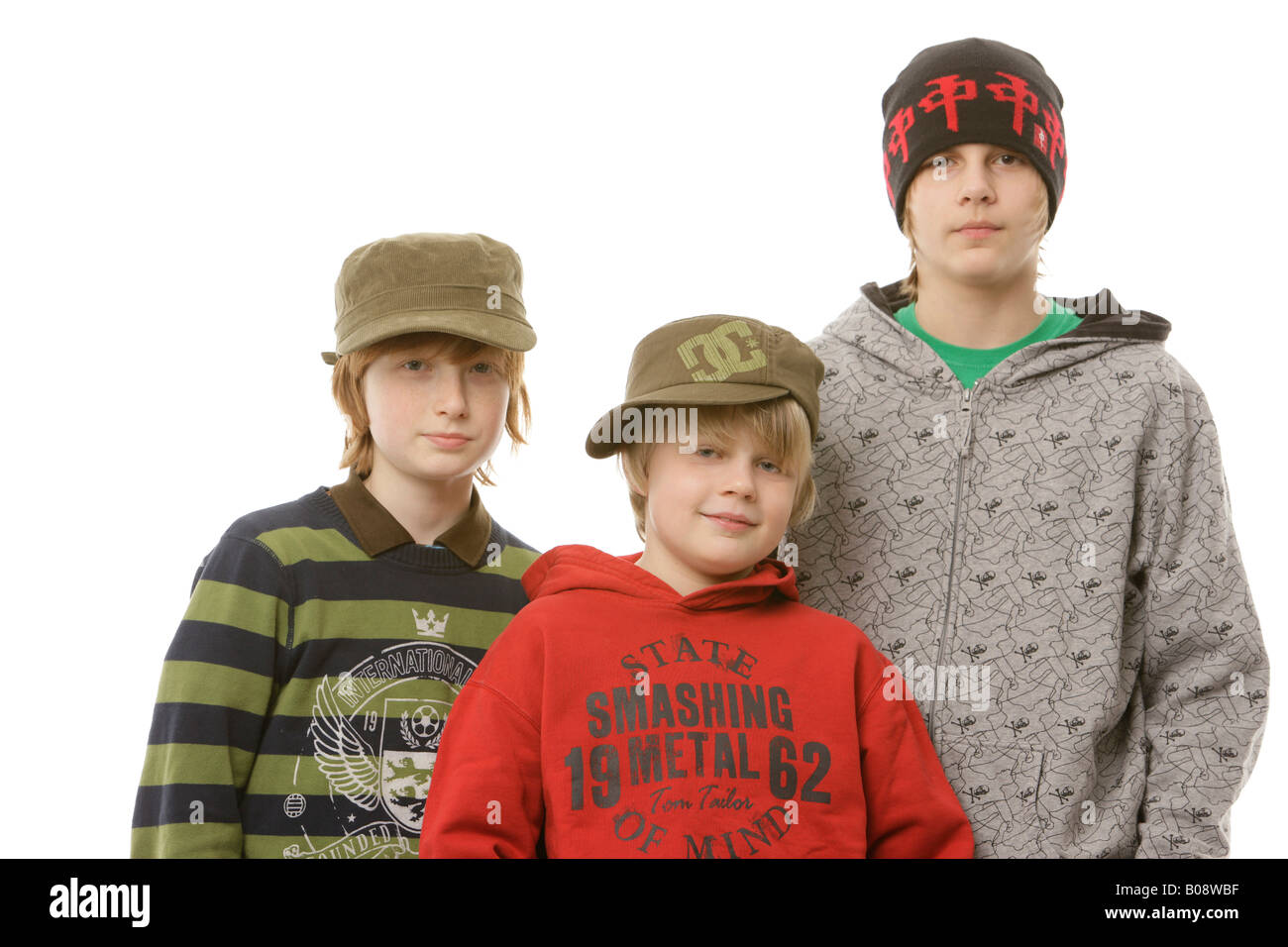 Three boys, 10, 12 and 13 years old, wearing caps, hats Stock
