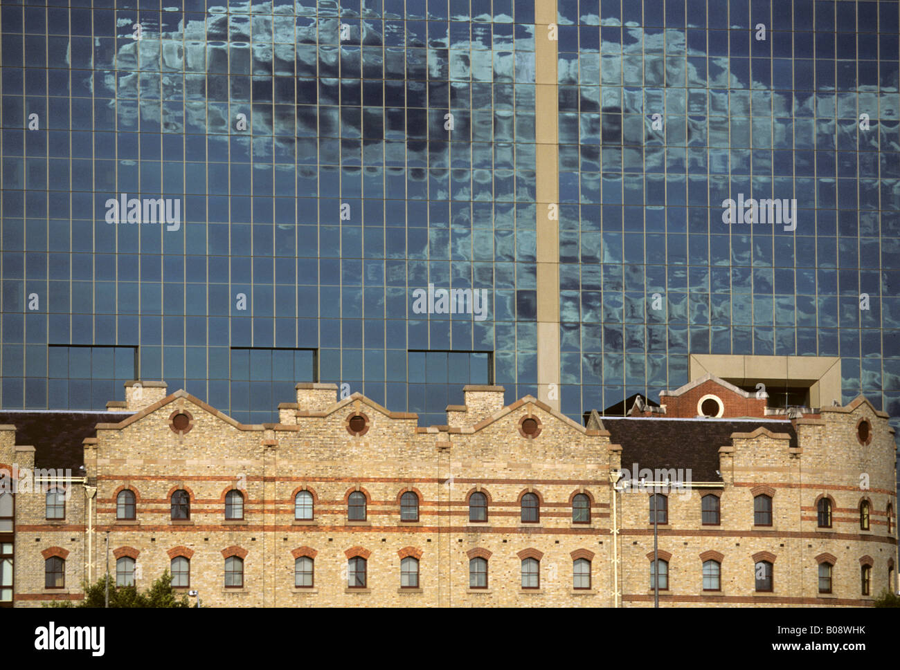 Old harbour building in front of modern glass office building, Darling Harbour, Sydney, New South Wales, Australia Stock Photo