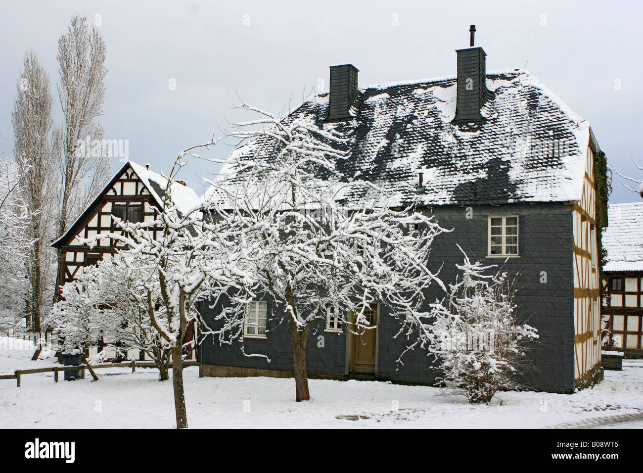 Snow-covered timbered houses in village of Hessenpark, Neu-Anspach, Hesse, Germany Stock Photo