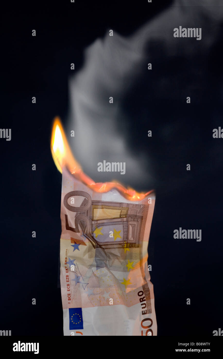 Burning 50-Euro bill, smoke - inflation Stock Photo