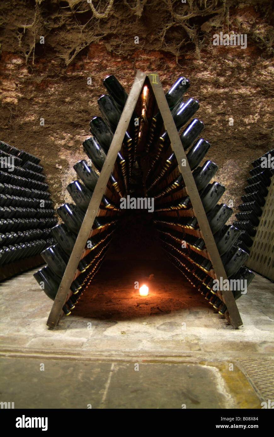 Wooden shelves for storing champagne bottles during the fermentation process in an old vault cellar, Kessler sparkling winery,  Stock Photo