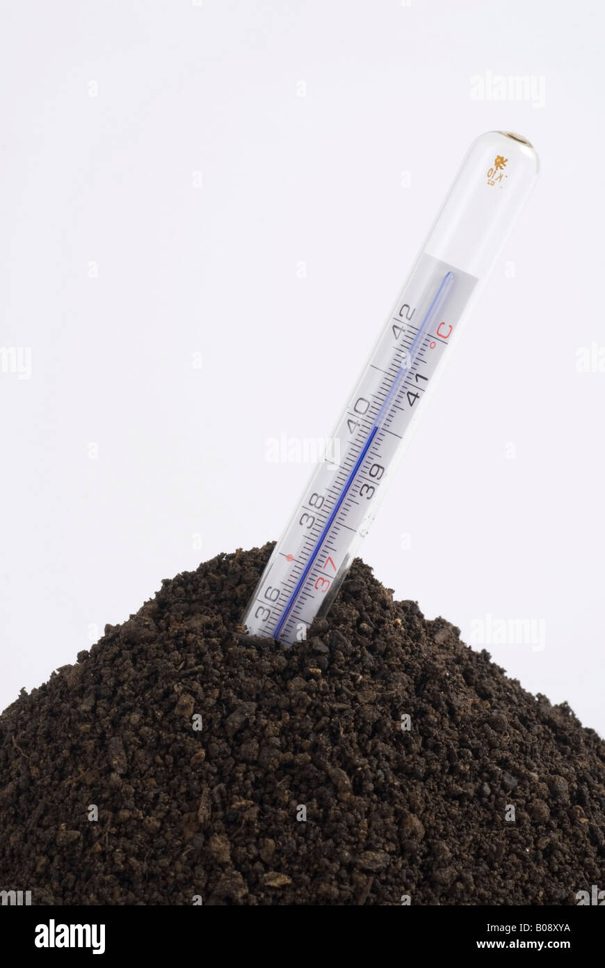 Thermometer in a pile of soil, symbolic for global warming Stock Photo
