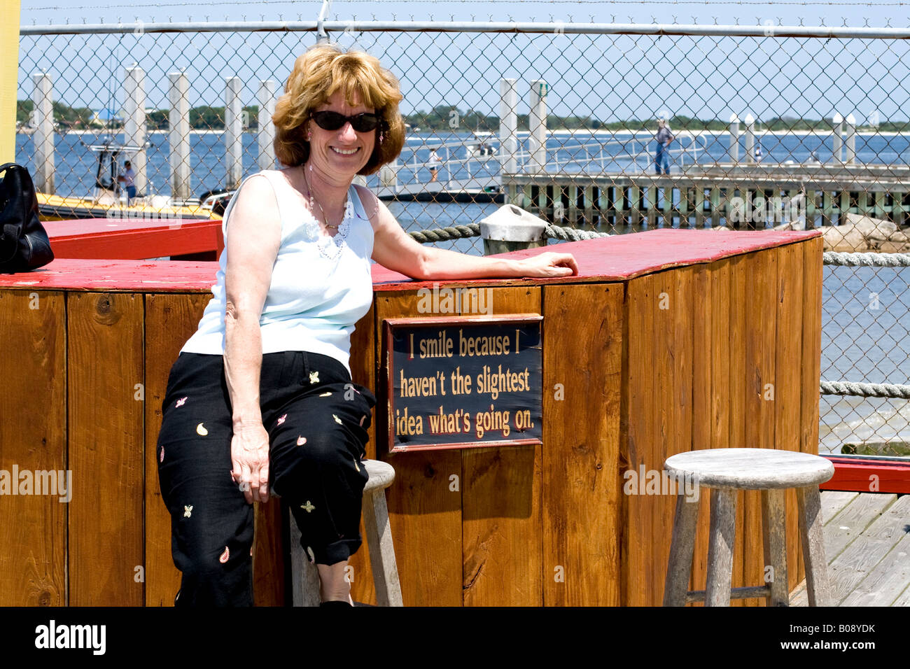 Woman sitting on bar stool hi-res stock photography and images - Alamy