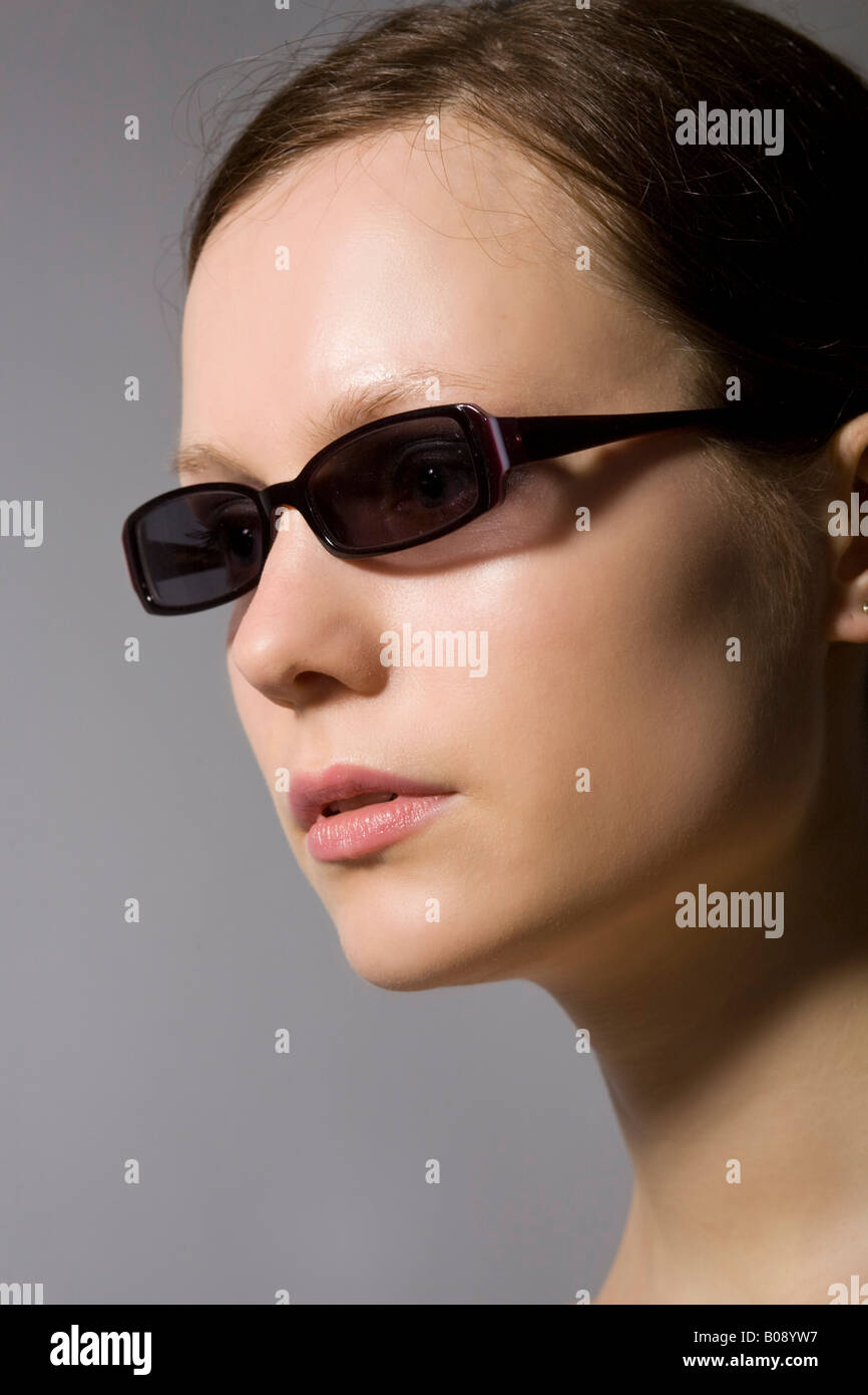 Young dark-haired woman wearing sunglasses Stock Photo