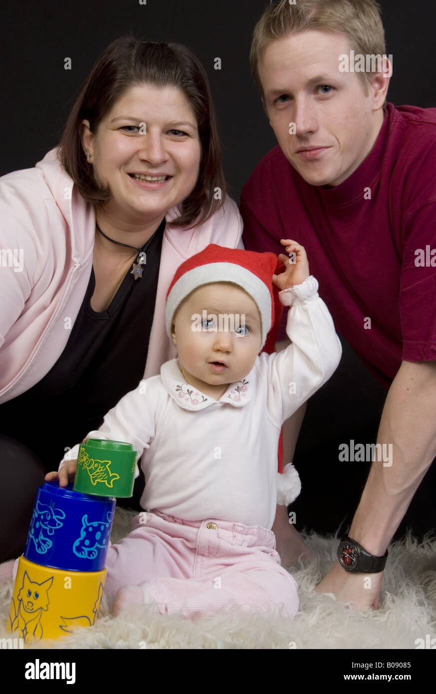 parents and baby with christmas cap Stock Photo