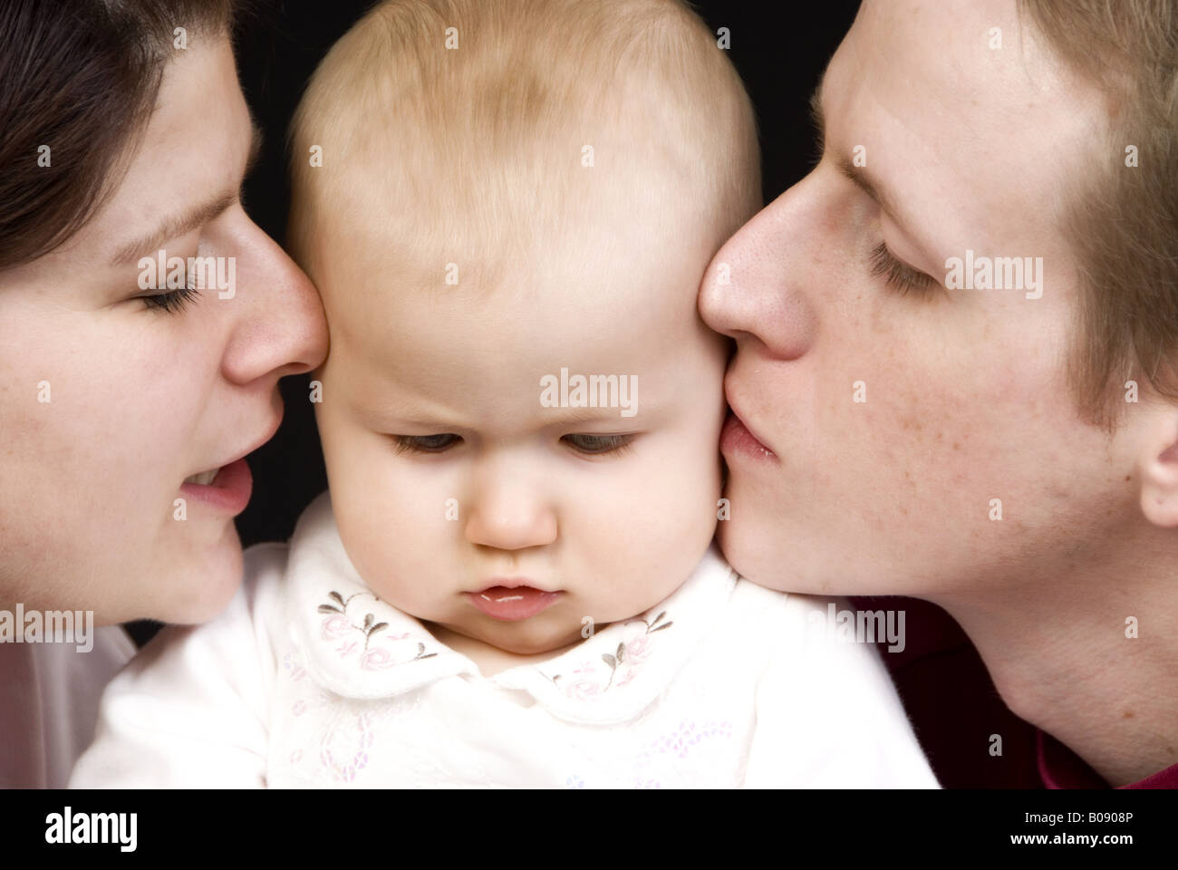 Parents kissing child lips hi-res stock photography and images - Alamy