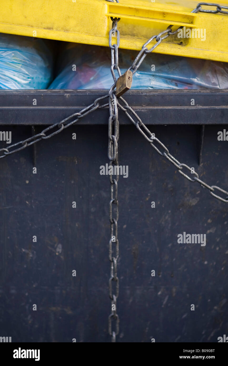 Waste container tied up with chains Stock Photo