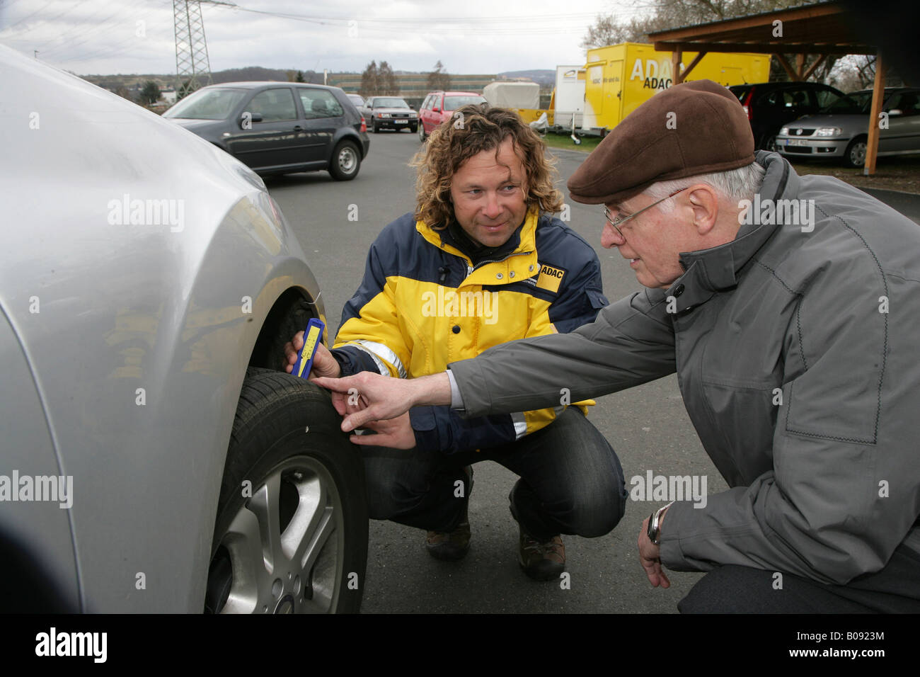 Dirk Mueller, ADAC (German automobile club) instructor explaining the importance of the correct tire tread depth and air pressu Stock Photo
