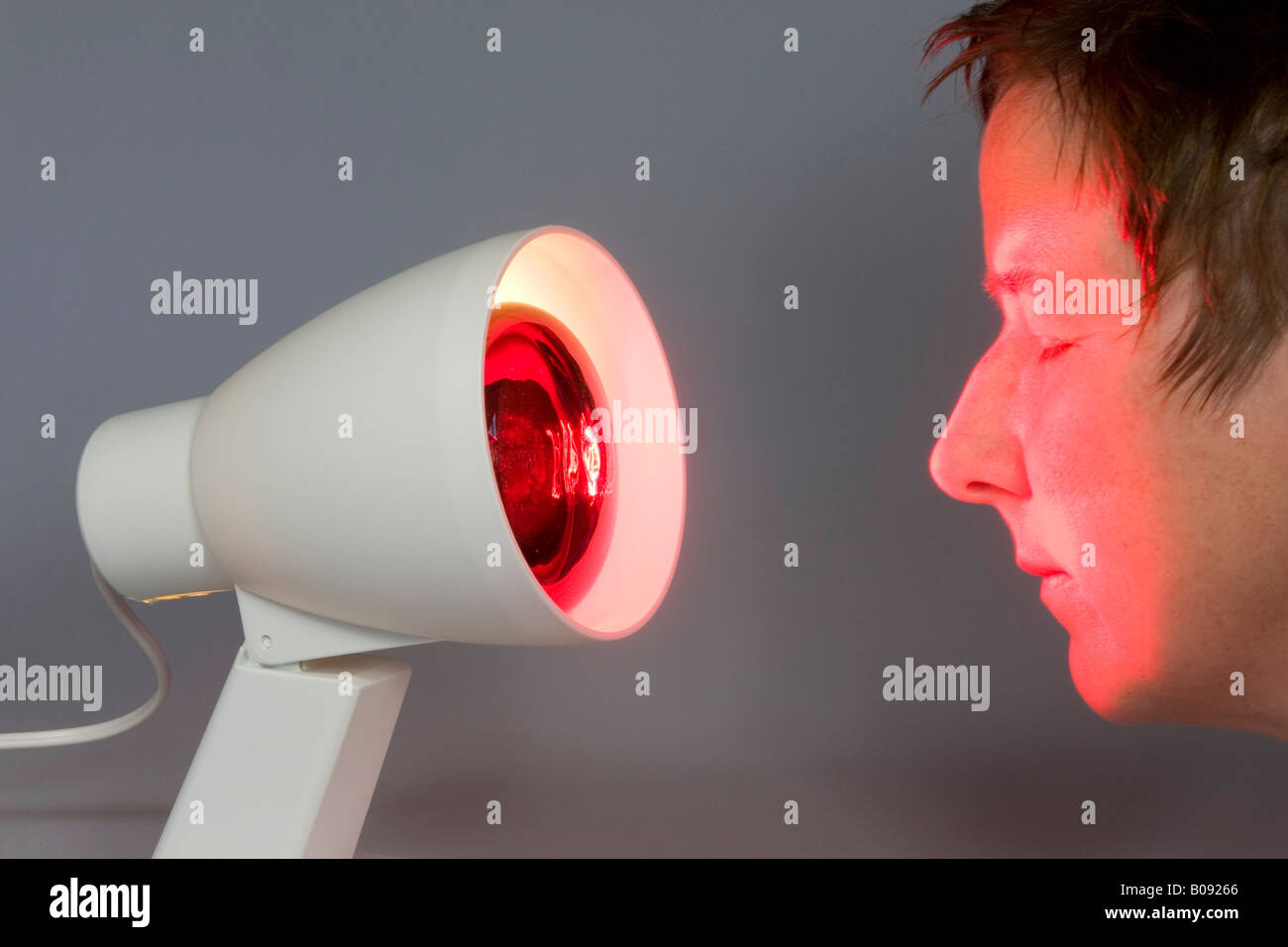 Infrared lamp, light beaming at a woman's face Stock Photo - Alamy