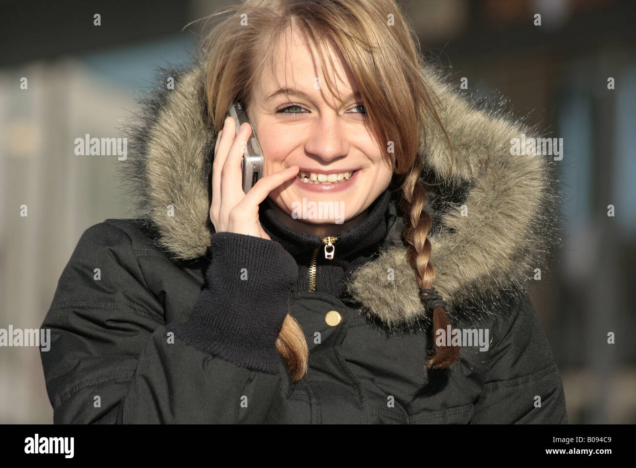 girl in winter jacket with fur collar and a cellular, Germany Stock Photo