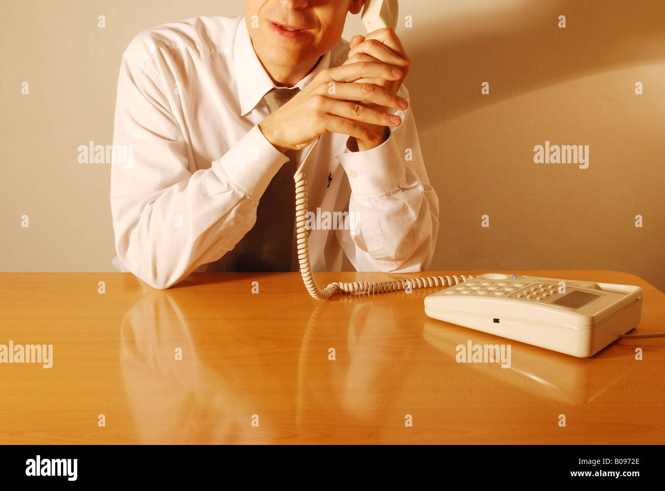 Hand gestures: talking on the phone. Covering the microphone. Stock Photo