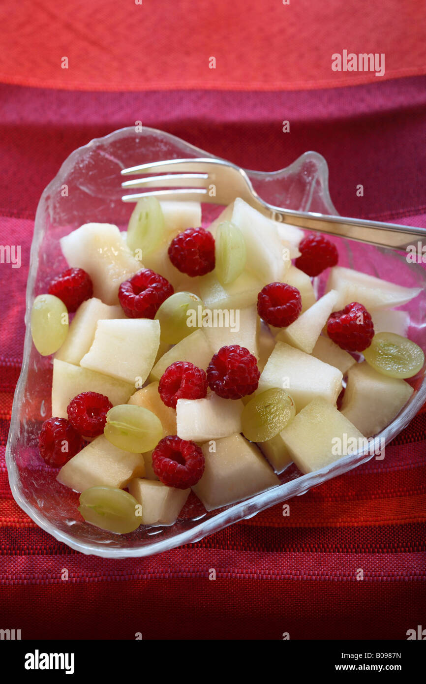 Fruit salad with honeydew melon, grapes and raspberries Stock Photo