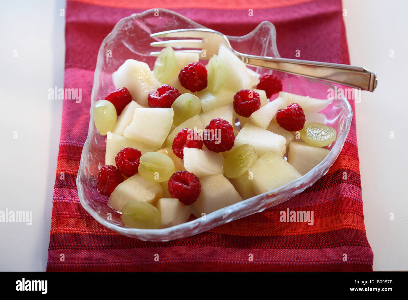 Fruit salad with honeydew melon, grapes and raspberries Stock Photo