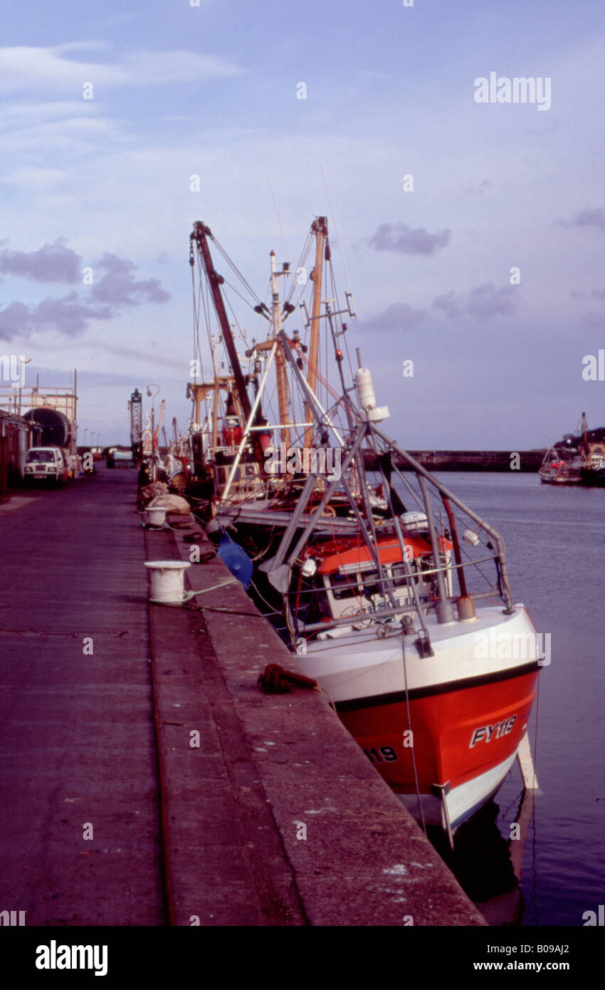 Boats leaning on Newlyn Harbour Stock Photo Alamy