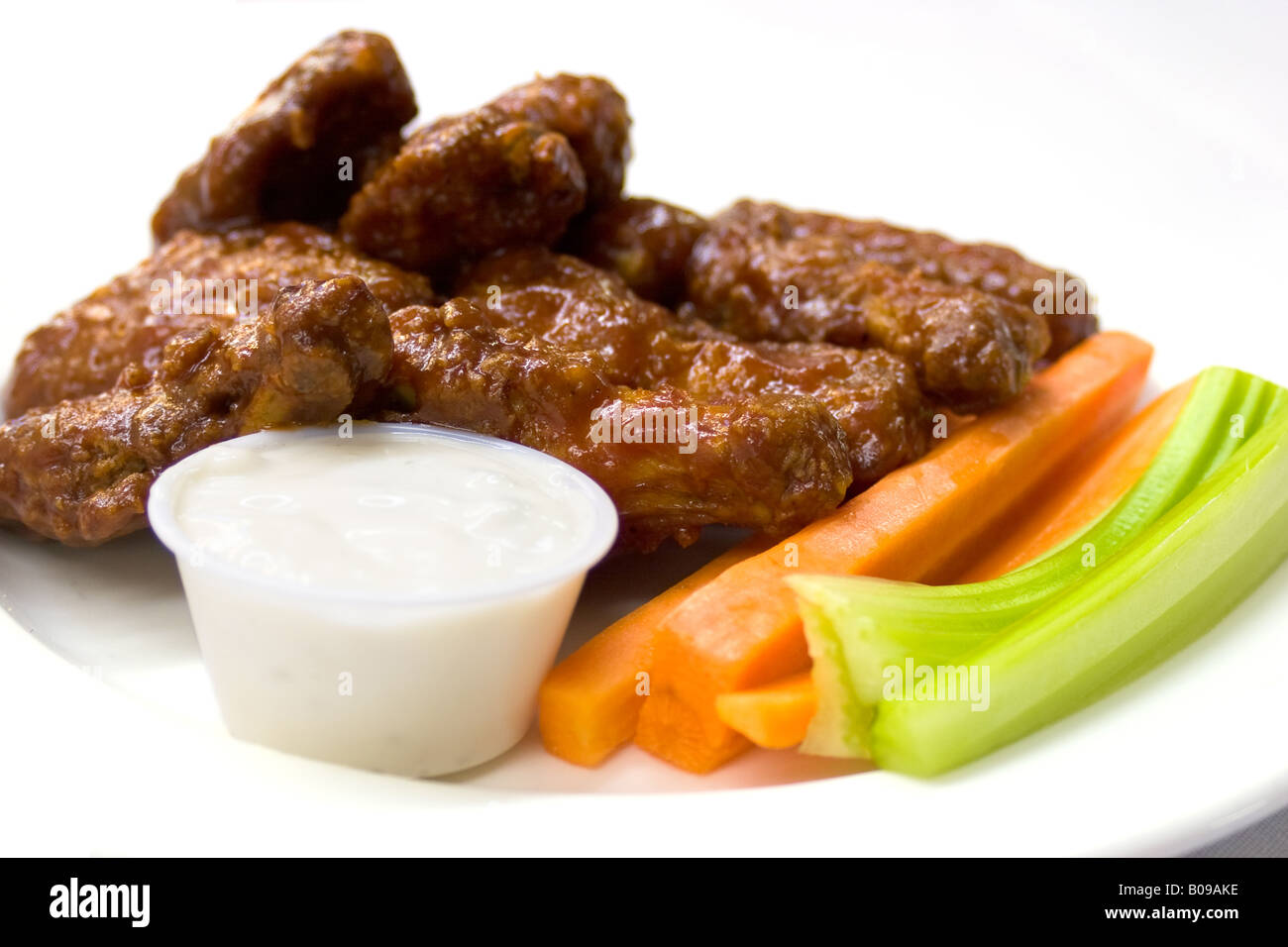Spicy chicken wings served with carrots and celery and a dipping sauce
