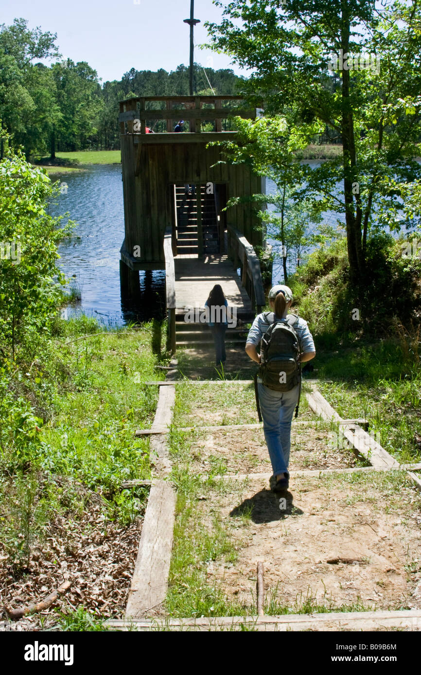 Girl walking to fort on lake Stock Photo