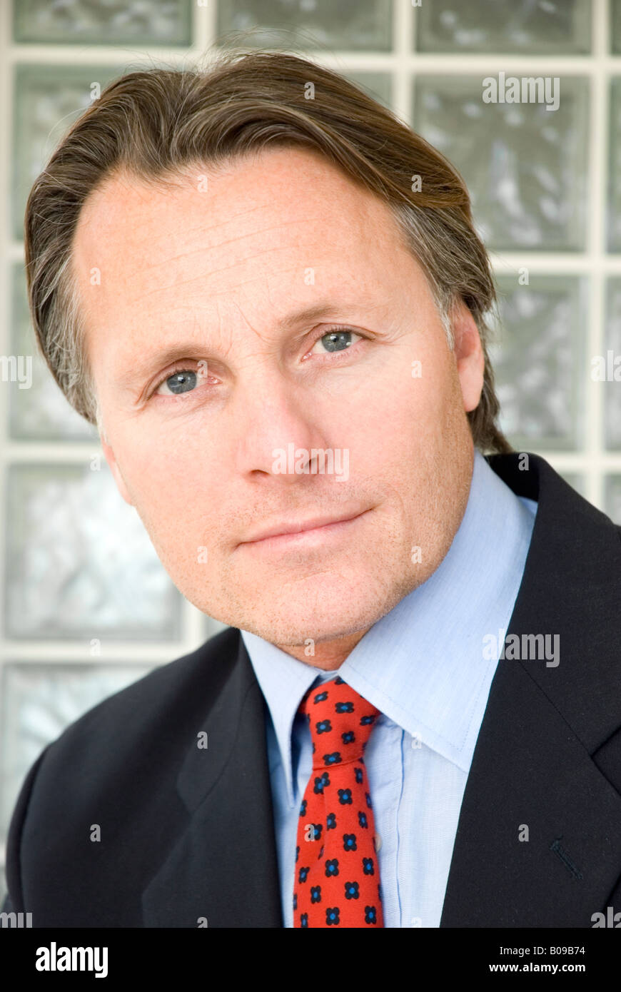 A 43 year old businessman looking straight at camera wearing a smart suit. Stock Photo