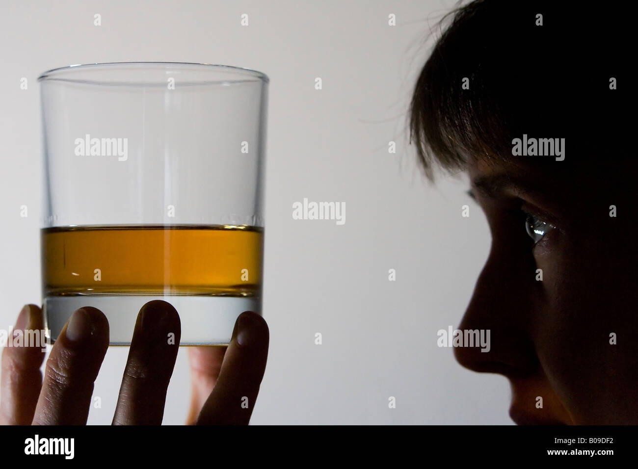 Woman looking at whisky in glass, Scotland Stock Photo - Alamy