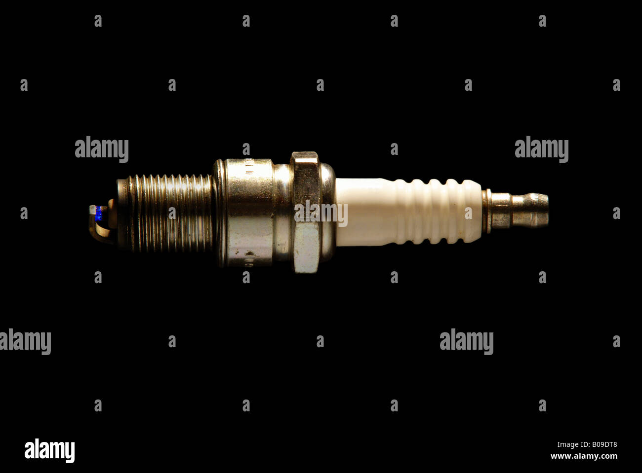 A used spark plug with a real spark jumping between the electrodes Stock Photo Alamy