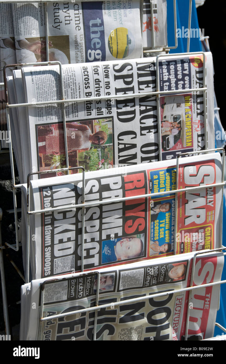 UK British National tabloid newspapers in rack outside newsagents shop Express Star and The Sun Stock Photo