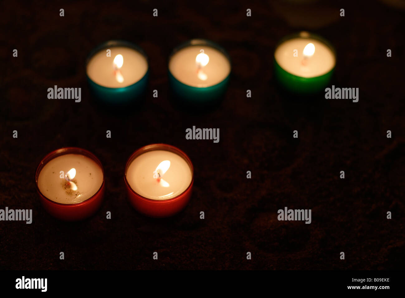 Five coloured lit church candles Stock Photo Alamy