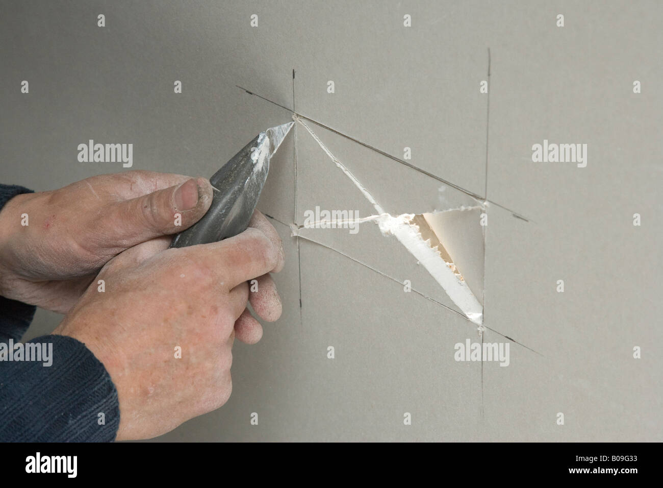 builder cutting hole in plaster board drywall Stock Photo Alamy