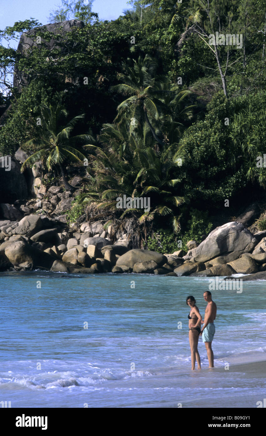 People taking a bath in Anse Georgette, Praslin Island, Seychelles Stock Photo