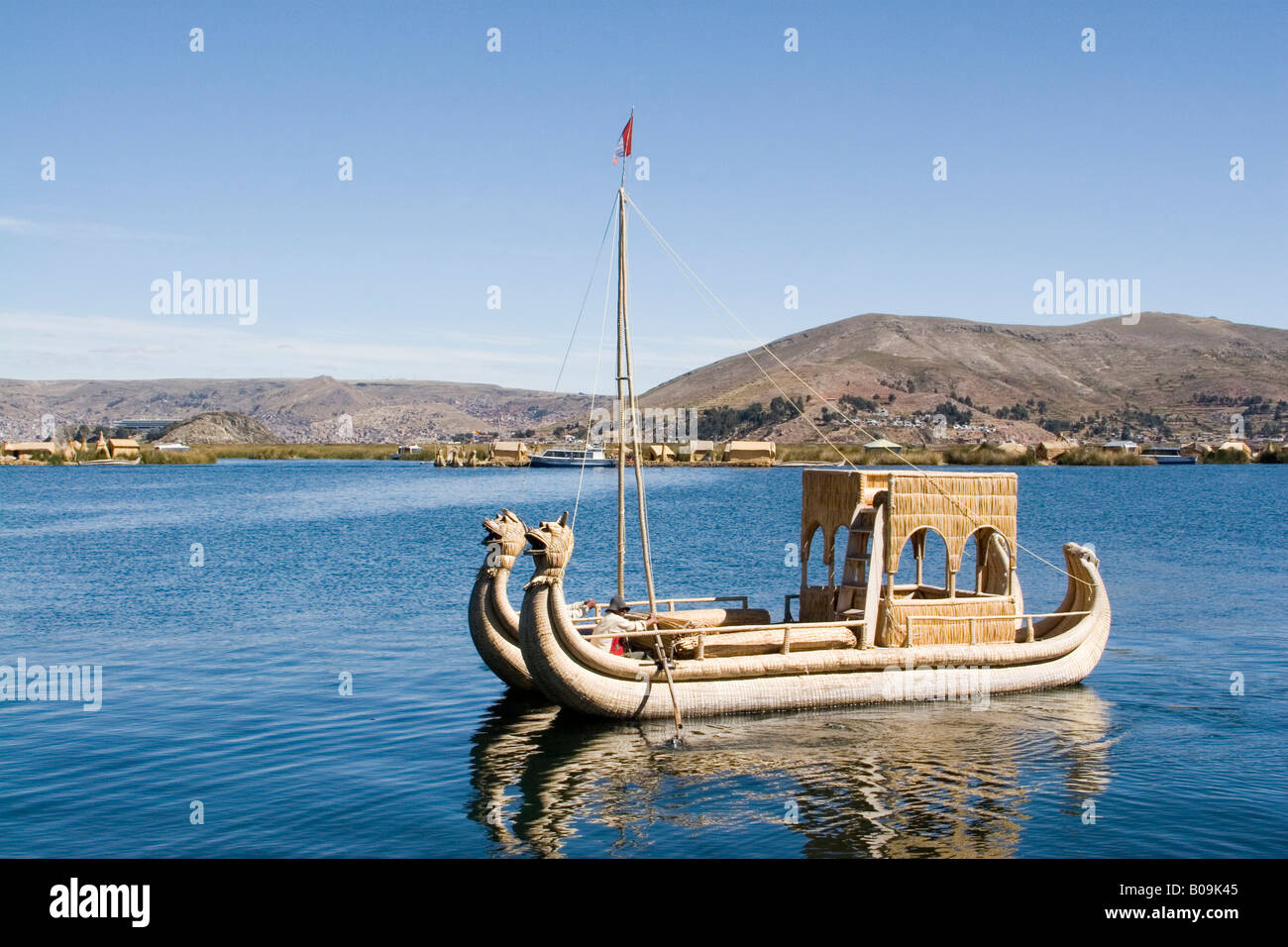 South America - Peru. Reed boat moving through channel along a floating ...