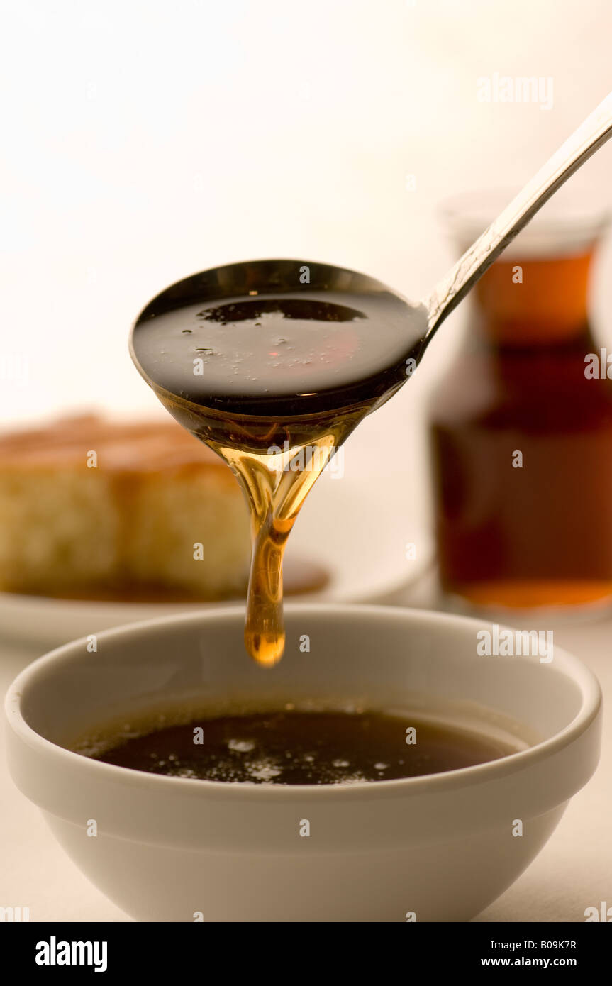 Syrup dripping from a ladle Stock Photo Alamy