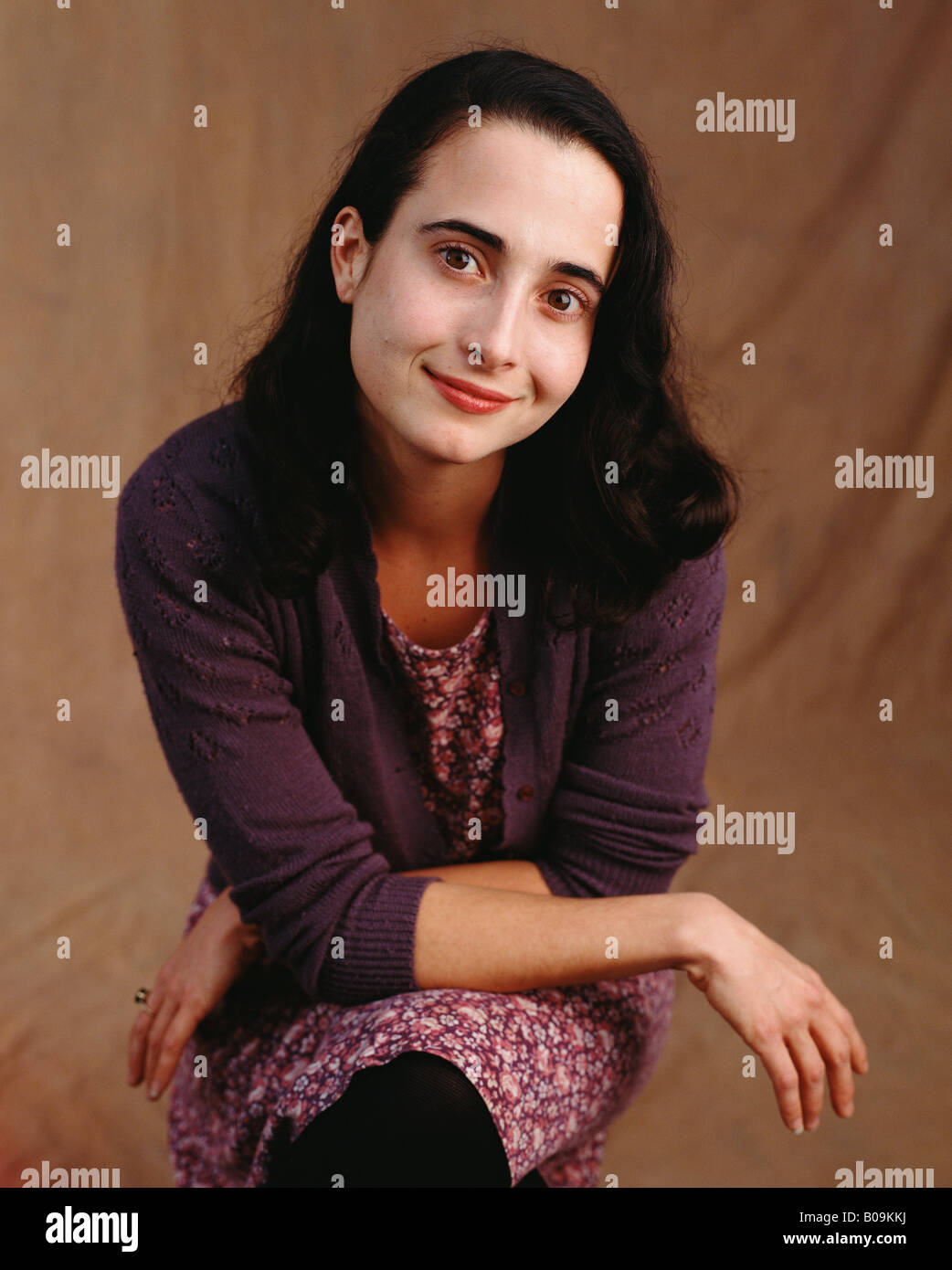 A studio portrait of a woman in her thirties smiling Stock Photo