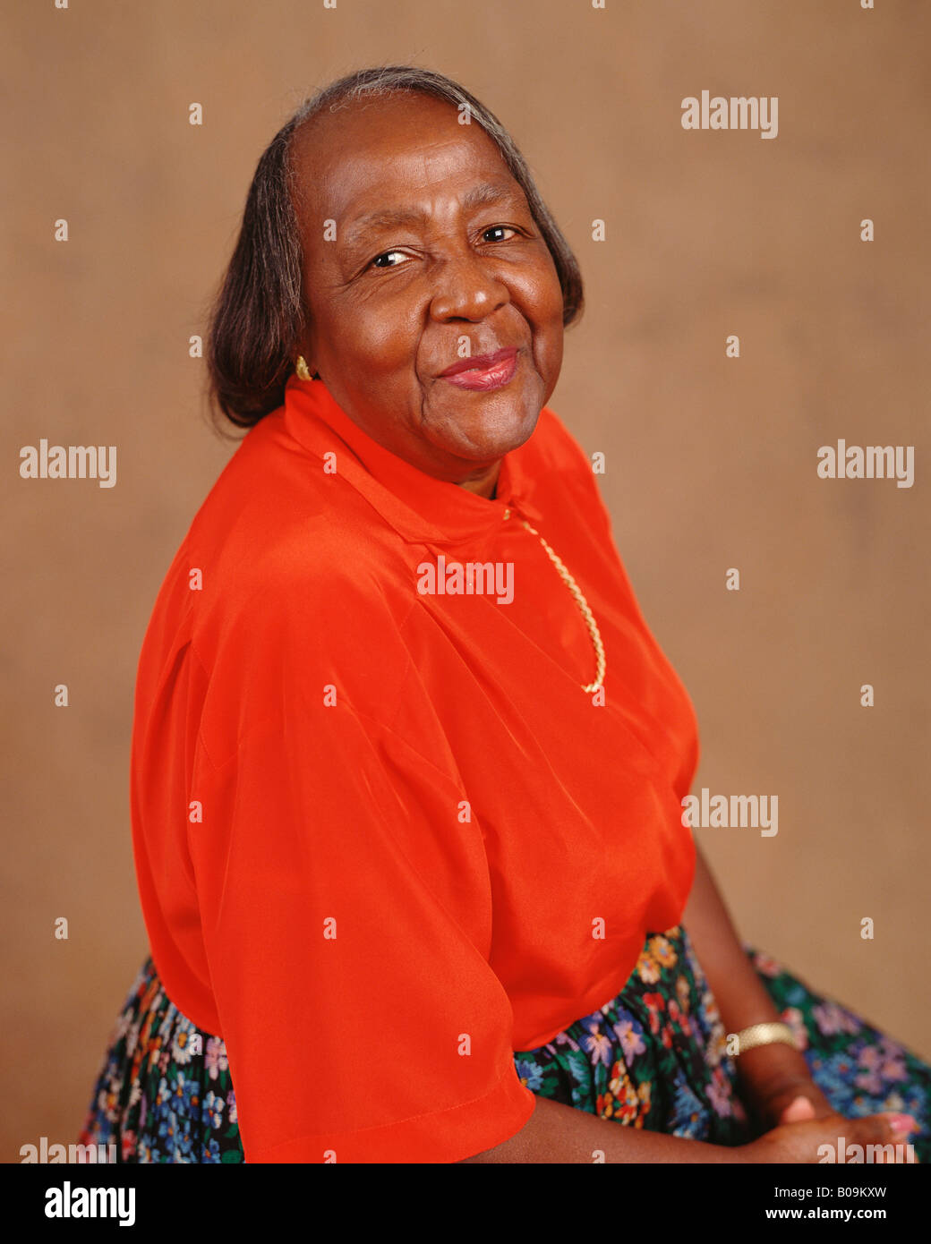 An African American middle age woman smiling for a studio portrait. Stock Photo