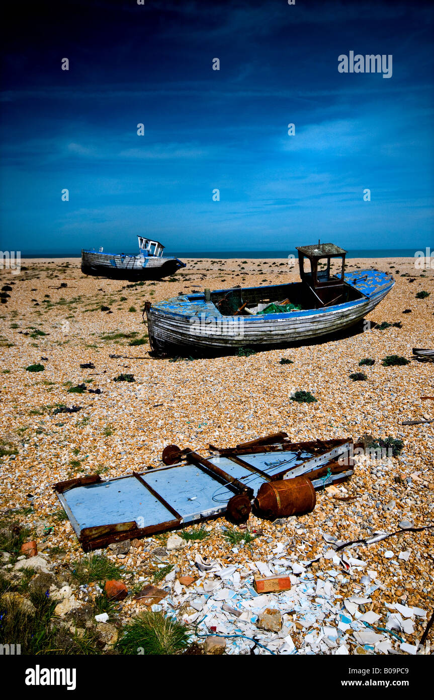 Dungeness - abandoned wooden fishing boats rotting on the beach at ...