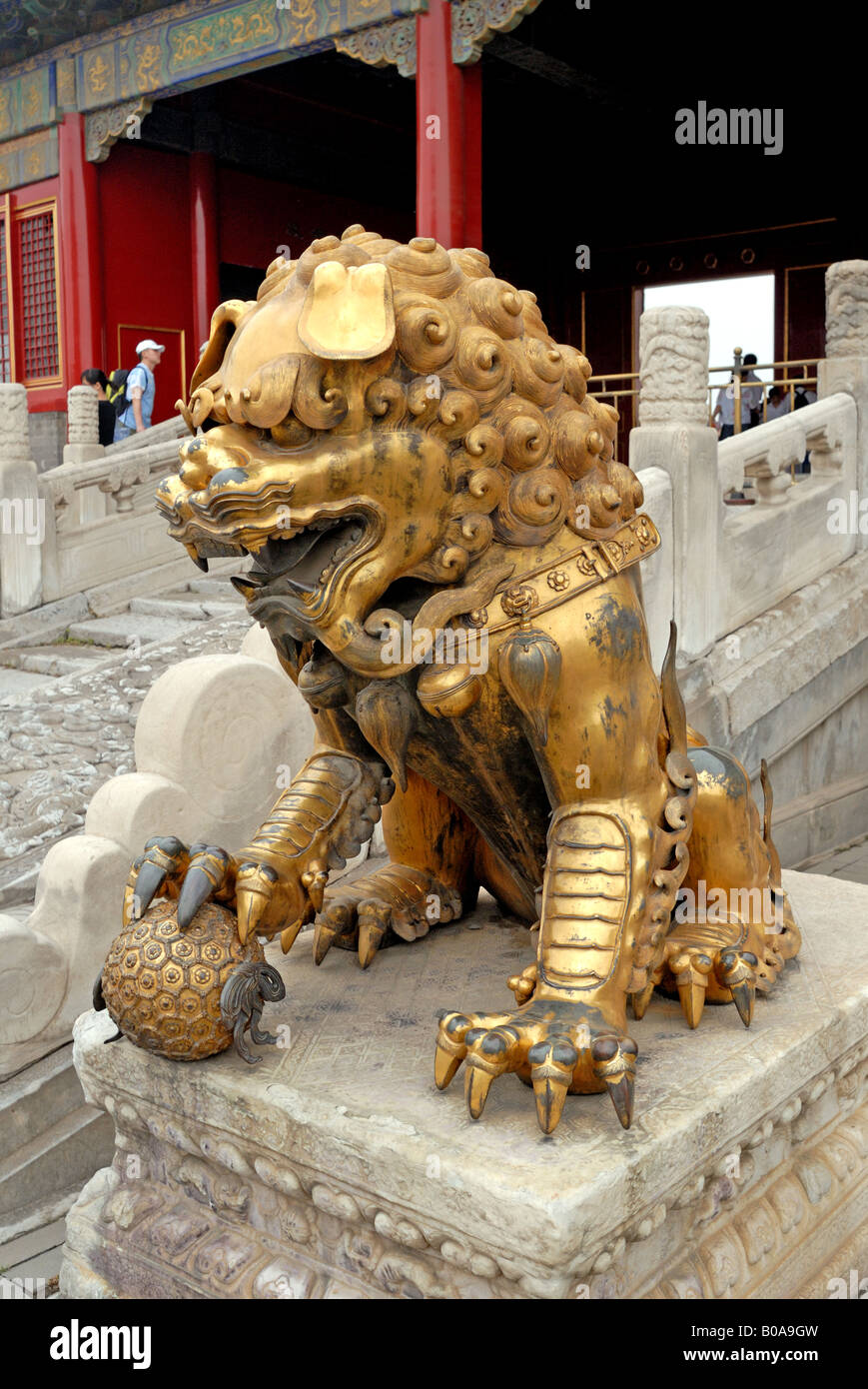 Male lion in the Forbidden City has a ball under its paw representing the imperial power China Asia Beijing Peking City Stock Photo