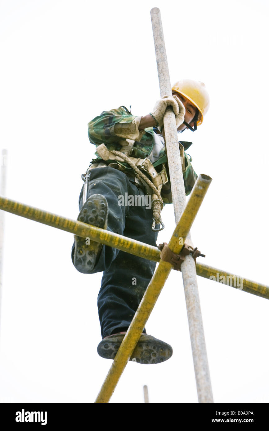 Construction worker standing on scaffolding, low angle view Stock Photo