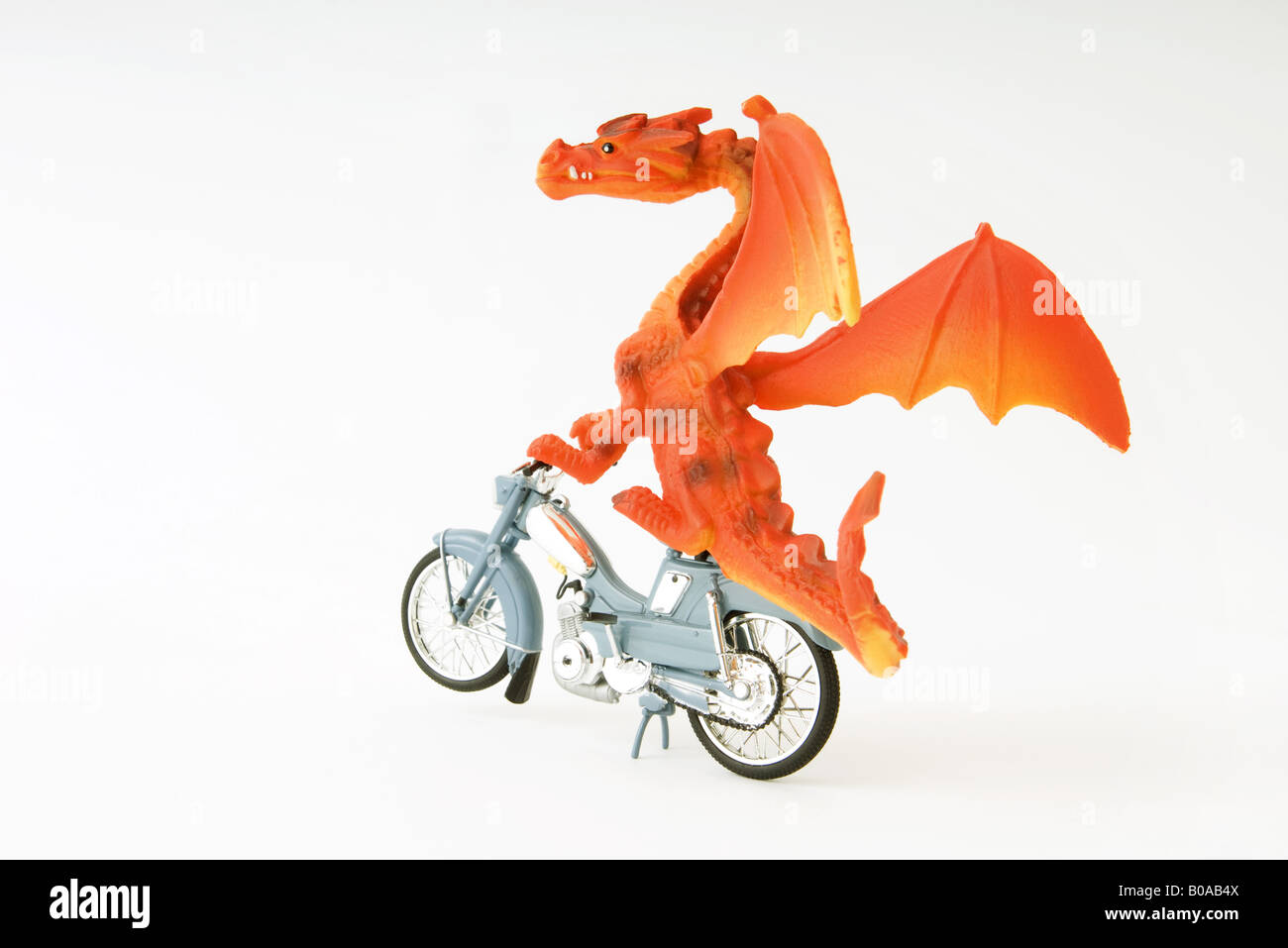 Toy dragon riding motorbike Stock Photo