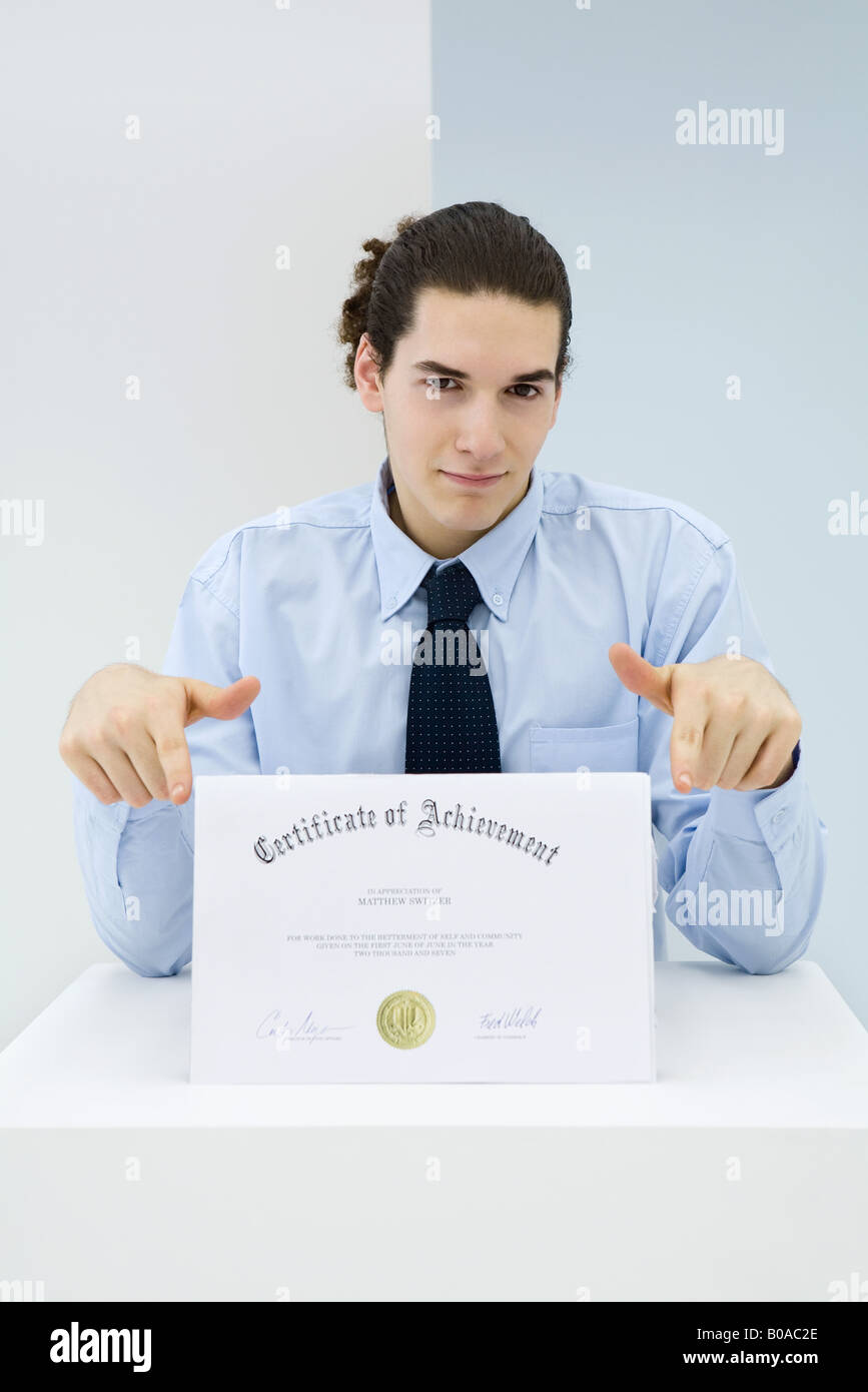 Young professional displaying certificate, portrait Stock Photo Alamy