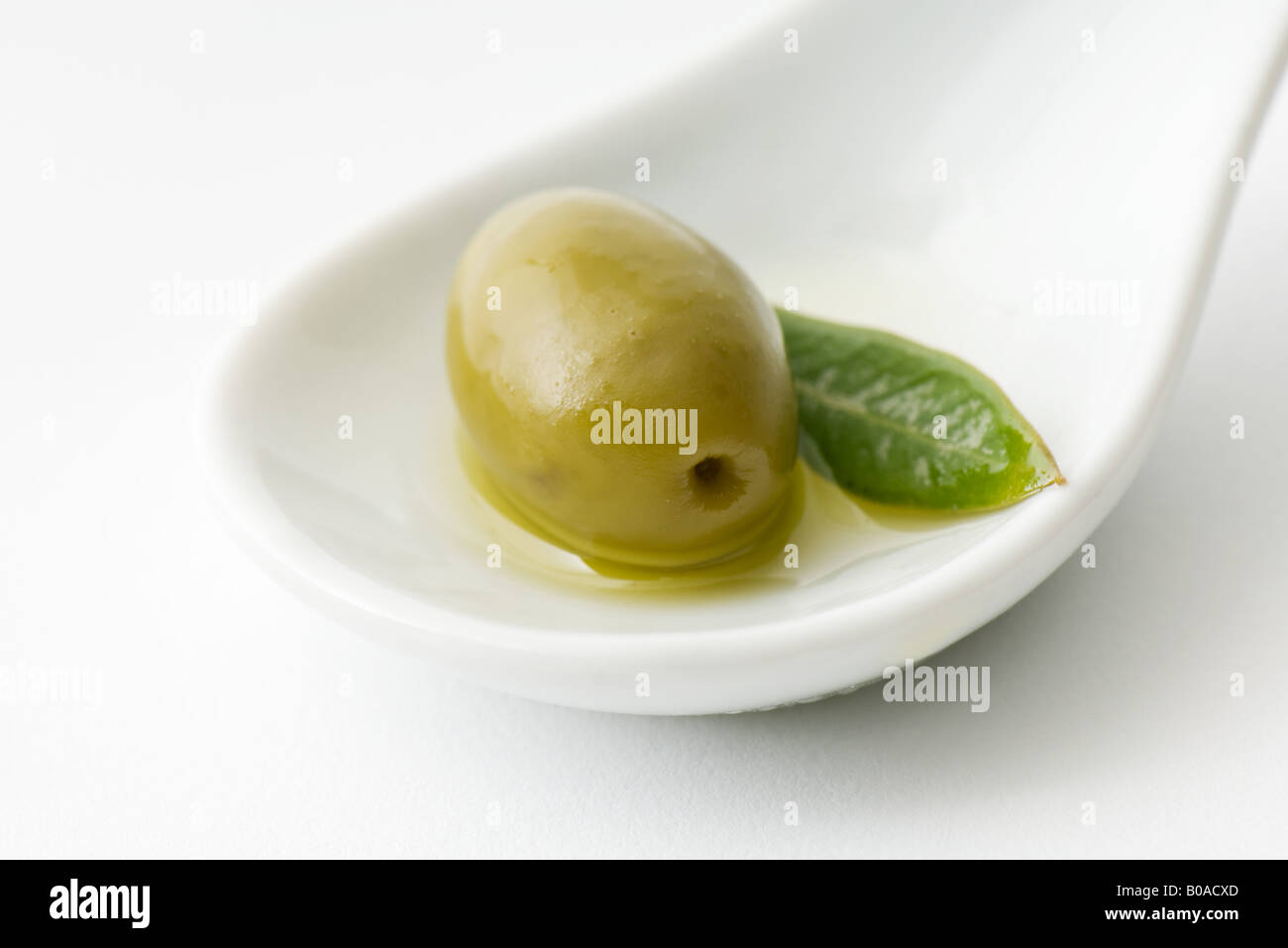 Green olive in spoon Stock Photo Alamy