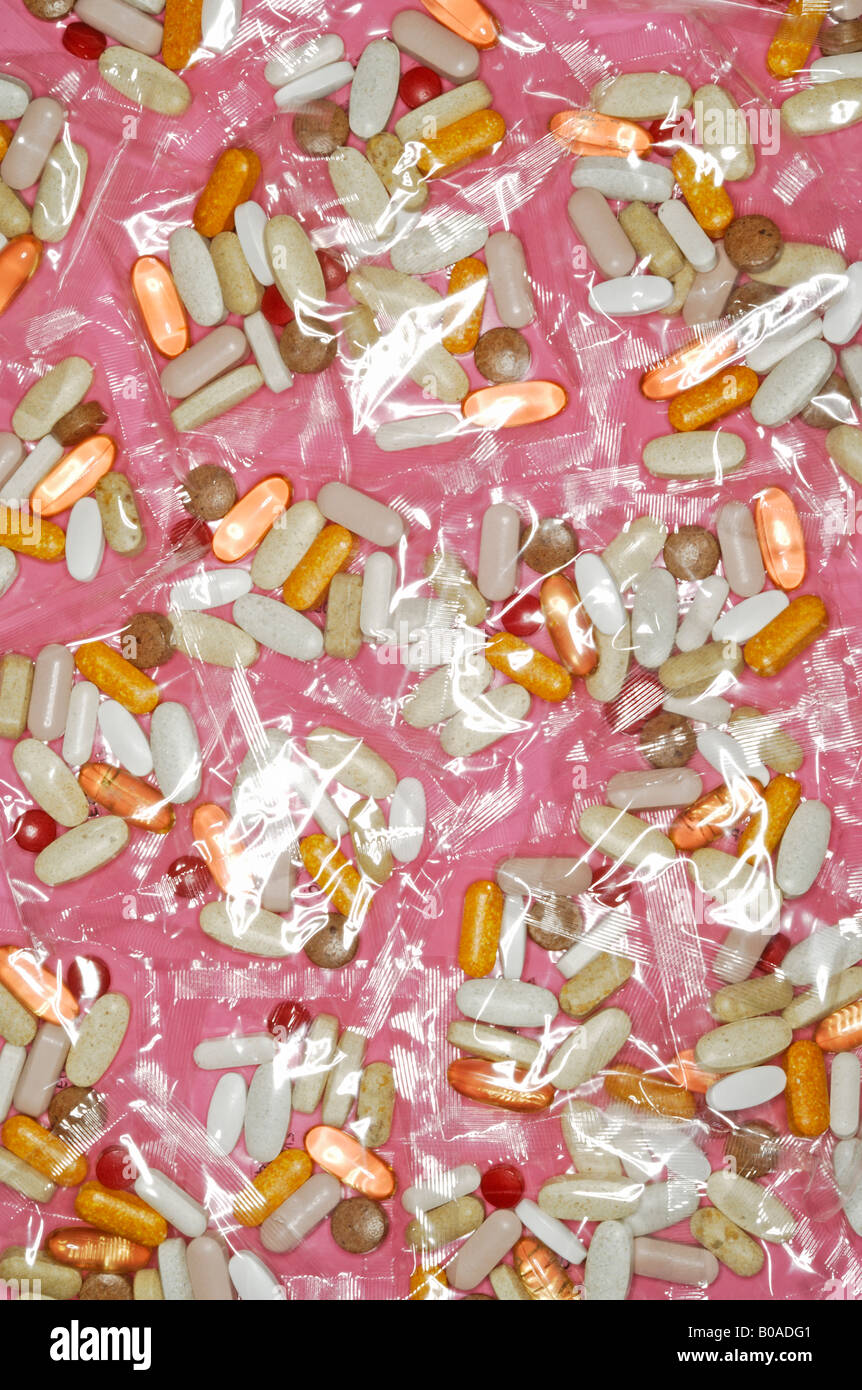 Multiple plastic packets of womens multi vitamins containing vitamins minerals amino acids antioxidants and nutrients. Stock Photo