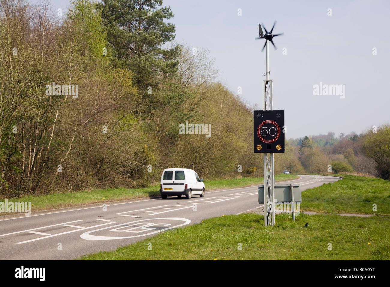 West Sussex England UK Wind powered 50 mph speed sign illuminated by vehicle on country main road Stock Photo