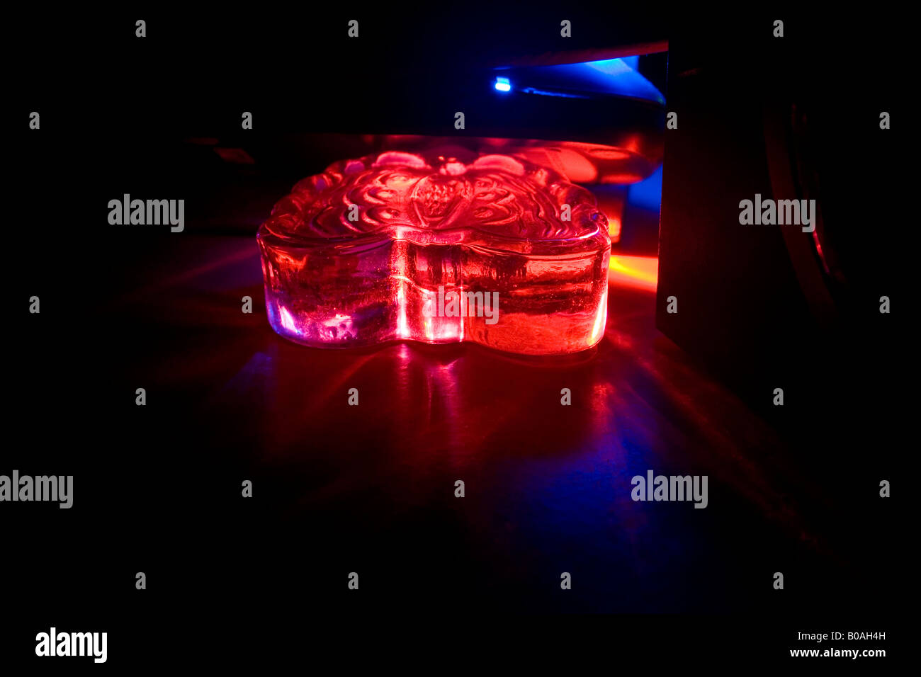 Red light through a glass sculpture Stock Photo Alamy
